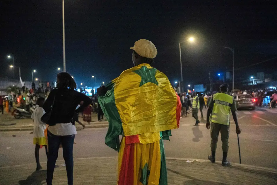 A supporter wears the Senegalese national flag in Dakar on February 2, 2022 after Senegal's win against Burkina Faso during the Africa Cup of Nations 2021 semi-final football match. © 2022 CARMEN ABD ALI/AFP via Getty Images
